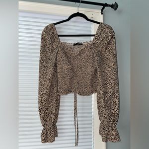 Off-shoulder cheetah print blouse.